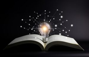 A light bulb hovering over an open book